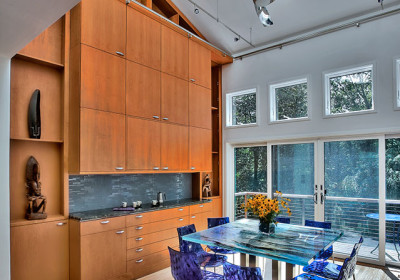 dramatic breakfast room with alder veneer cabinetry and artful accents