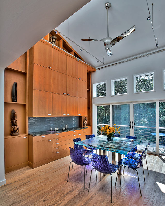 dramatic breakfast room with alder veneer cabinetry and artful accents