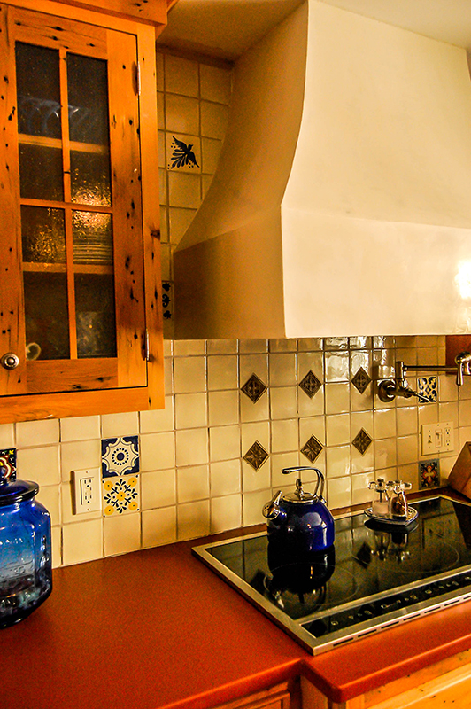 custom stucco hood and mexican tile backsplash in sw style kitchen